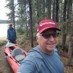 Dave and Russ porting their kayaks between lakes