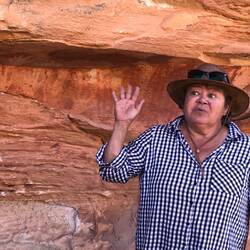 Loy explaining cave art on her family's land