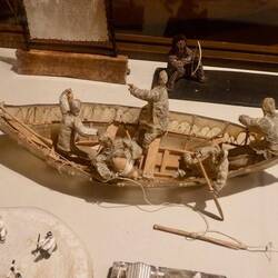 Model of a canoe and fishermen