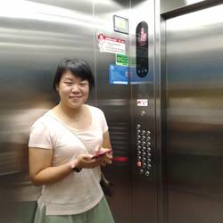 Carol in the hospital's elevator, leading me to the top to enjoy a night view over Liuzhou