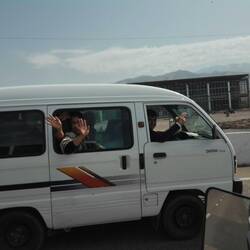 Locals waving from their car
