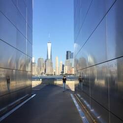 Rhonda at one of the 9/11 memorials with the new building replacing the twin towers showing