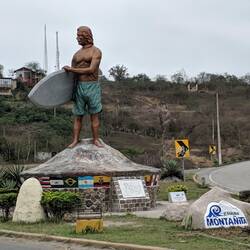 The statue at the entrance to Montanita leaves no question as to what this town is all about