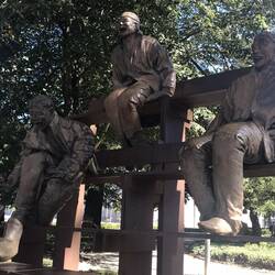 Statues of laughing old guys