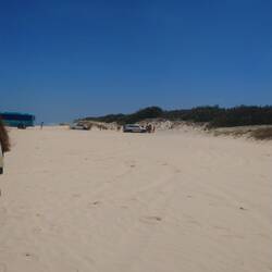 Guys try to get there car out of the sand.