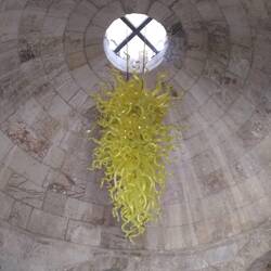 A Dale Chihuly chandelier hangs in the entrance hall of the Tower of David Museum