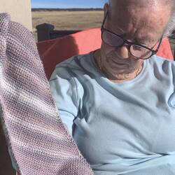 Mom showing off the scarf she's knitting — Colorado Springs, CO.