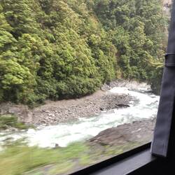 Rushing streams alongside the train