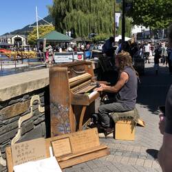 Busker playing a piano he rescued from the trash