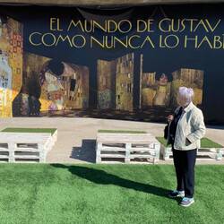 Checking out the Klimt exhibit poster in Malaga, Spain.