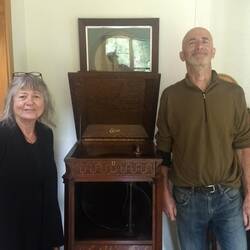 Nature-loving Jenny and Ian beside their working phonograph at Bushy Point Fernbirds BnB