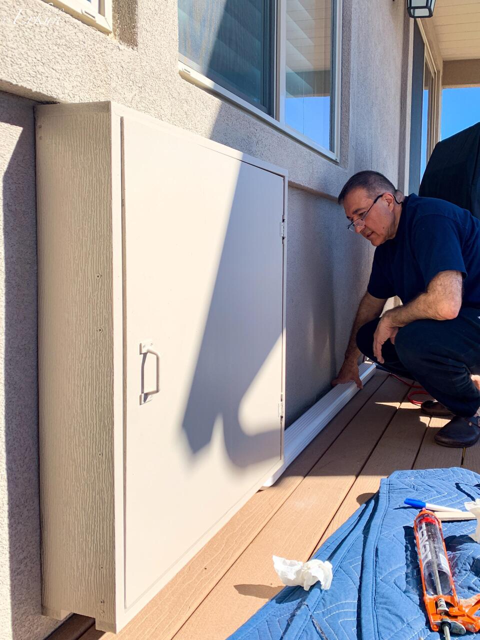 Mui built a cabinet to hide the gas hook-up and installed a conduit to hide the hose.