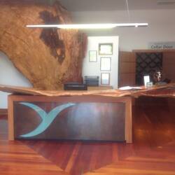 The immense Matai wood reception desk