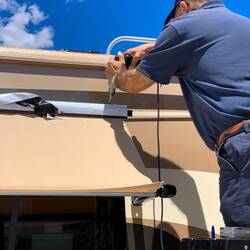 A screw through the polyrod and rail holds the awning in place.