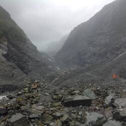 A very dirty glacier just visible amidst its terminal moraine