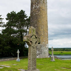 Replica of the Cross of Scriptures and O'Rourke's Round Tower — Clonmacnoise, Ireland.
