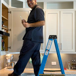 Mui prepping for the installation of lights in the upper cabinets — Colorado Springs, CO.