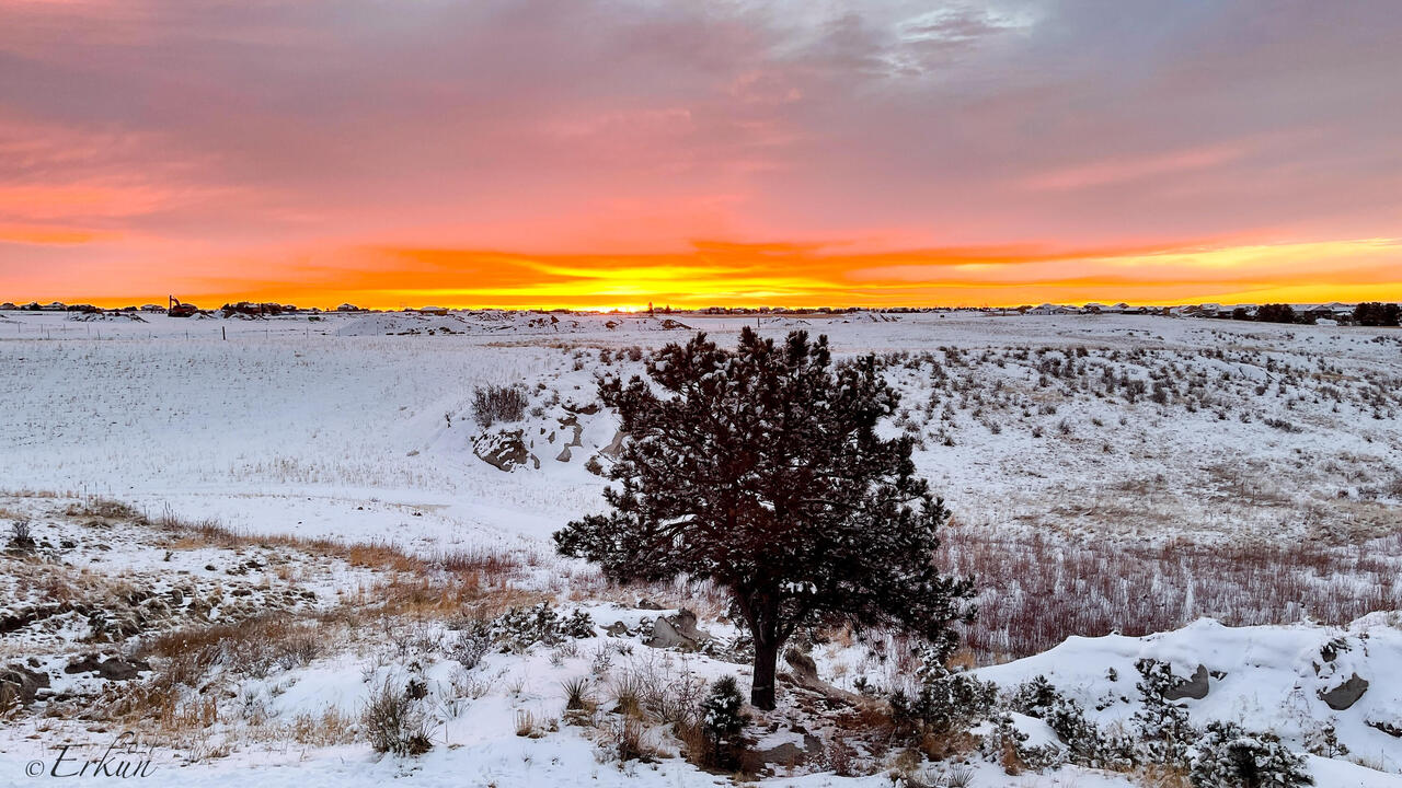 Colorful sunrise with a snow-covered landscape — Colorado Springs, CO.