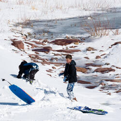 The kids are out with their sleds, playing in the arroyo Winter wonderland — Colorado Springs, CO.