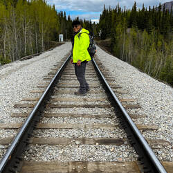 To get to the Horseshoe Lake Trailhead by the sign, we walk on the railroad ties — Denali NP, AK.