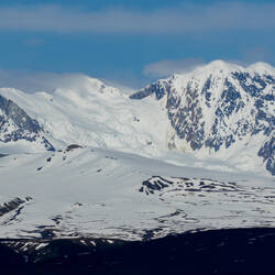 A distant peak and glacier in the Alaska Range — Denali Hwy, AK.