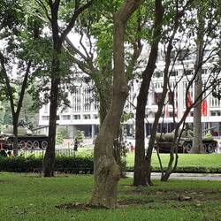 Independence Palace with red flags and tanks