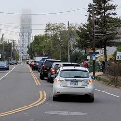 Cars backed at Aerial Bridge as boat heads through.