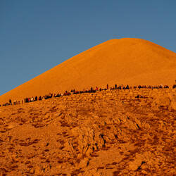 Visitors watching the sunset with the tumulus as a backdrop — Mount Nemrut ... Adıyaman, Turkey.