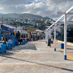 The promenade lined with eateries ... the cat is begging for fish at our table — Karaburun, İzmir.