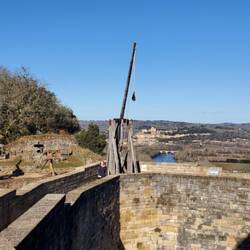 Charlotte next to one of the several trebuchets on display.