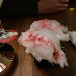 Foie gras, cotton candy with raspberry powder on a parmesan crisp