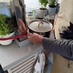 Tying up the pot of marmalade.