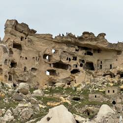 Abandoned cave homes near restaurant