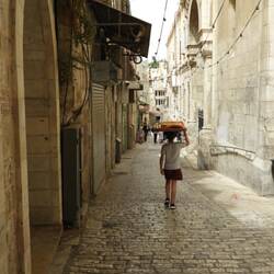 Local boy carrying bread on his head
