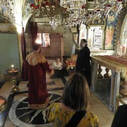 Priests blessing the front of the crucifix