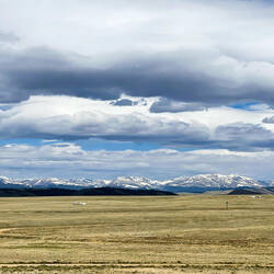 The snow-frosted Rockies are off in the distance — Along US-24, Colorado.
