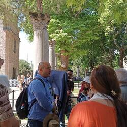 Local tour guide Mr. Fatih explaining outside HS