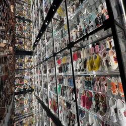 This wall was double sided-- a private collectors inventory of Gucci sneakers