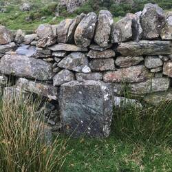 This milestone presumably refers to Dolgellau on an old road before motor vehicles.