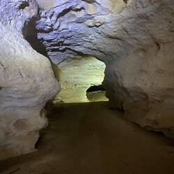 The cave dips, turns and branches.