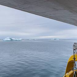 Mother Nature's ice sculpture ... framed by the lifeboat davit opening — Disko Bay, Greenland.