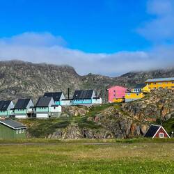 Blue skies add charm to the colorful buildings — Sisimiut, Greenland.