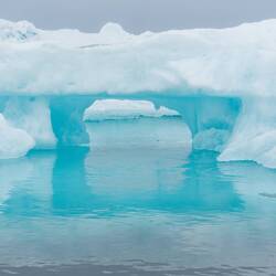 An eroded berg with a window — Baffin Bay, Greenland.