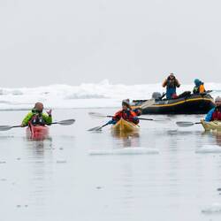 The sea kayak group is enjoying a paddle amongst the ice — Baffin Bay.