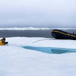 Mui gets down and wet for his reflection photo op — Baffin Bay, Greenland.