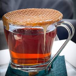 Stroopwafel, a gooey caramel treat warmed up with the steam from a cup of hot tea.