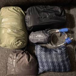 Sleeping bag, sandals and flip flops (shower), silk liner, water system, poncho, rain/wind shell
