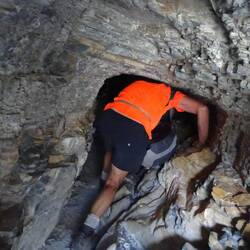 Crawling through tunnel entrance going down