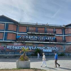 Derelict mansion (bricked up + graffitied) on the promenade in Deba