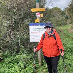 Bronwyn next to a newer sign